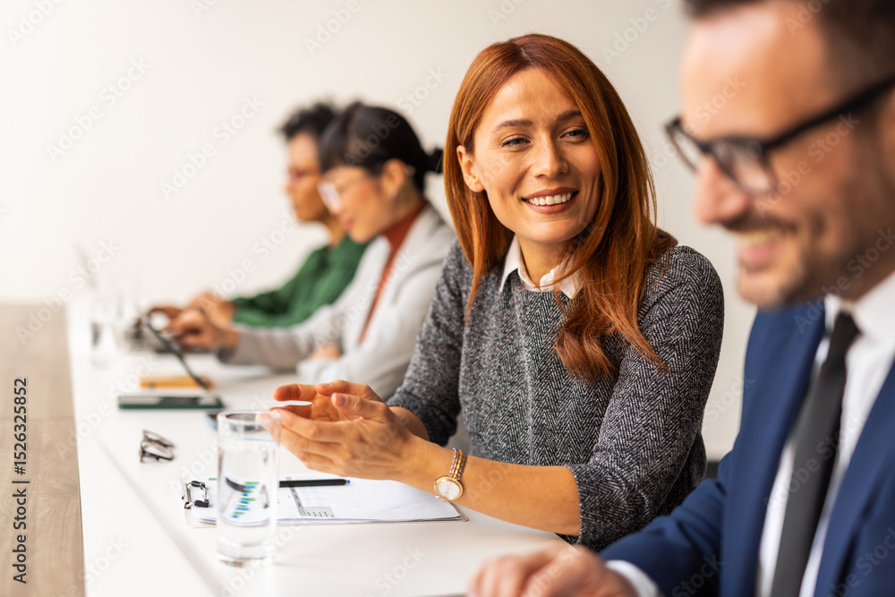 © Jelena - Business Professionals Collaborating in an Office Setting During a Productive Meeting