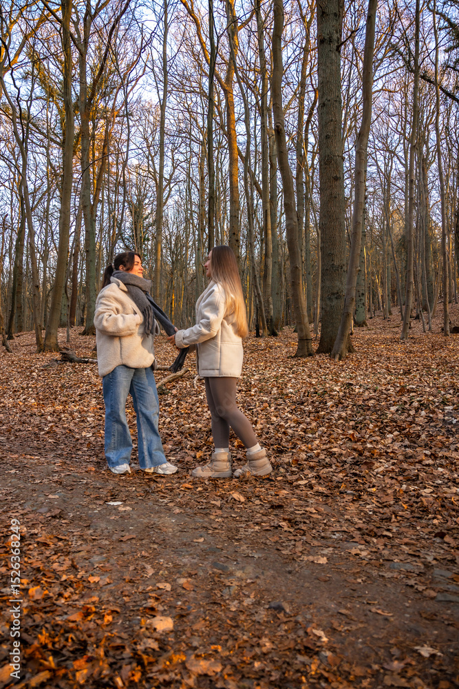 Two female friends on a walk in the forest. Friends walking through the forest. People in nature. Two female friends on a walk in the forest. Friends walking through the forest. People in nature.
