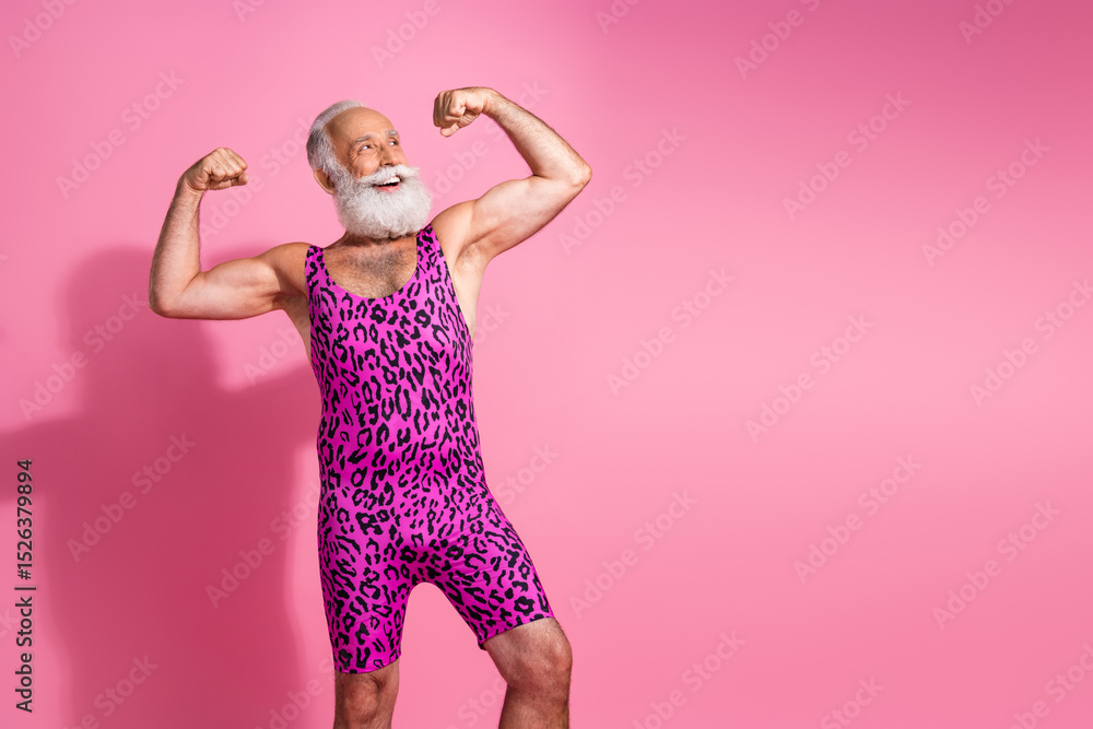 Photo of positive strong man wear stylish print clothes showing muscular body empty space isolated on pink color background Photo of positive strong man wear stylish print clothes showing muscular body empty space isolated on pink color background