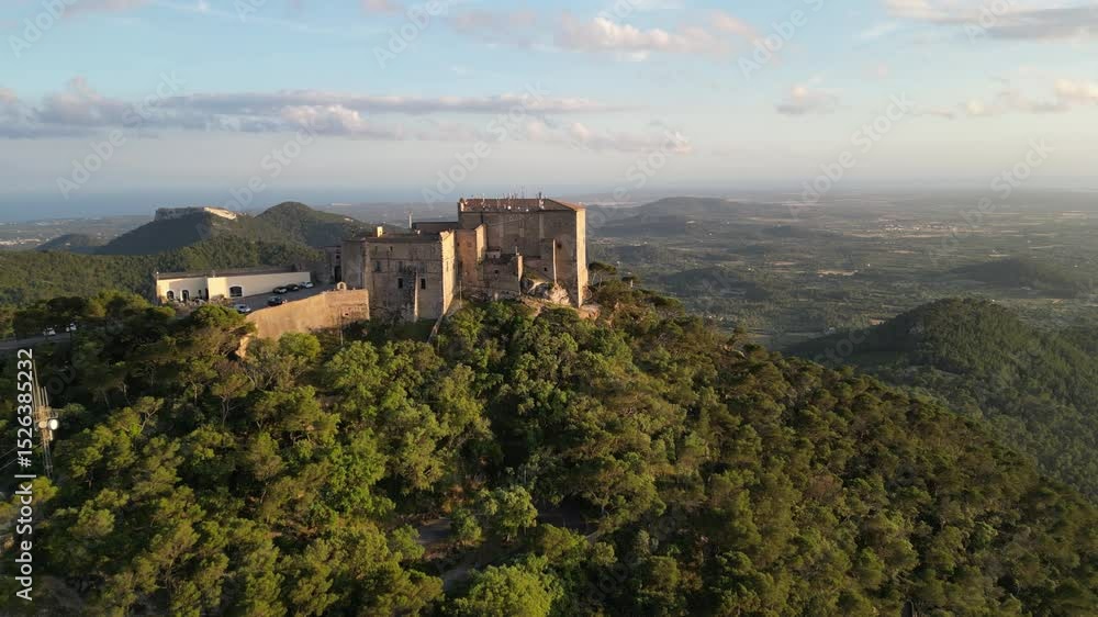 Aerial 4K drone view of Creu de Sant Salvador glowing at sunset. The hilltop cross rises above Mallorca’s peaceful hills, blending spiritual charm with golden light and sweeping island views. Aerial 4K drone view of Creu de Sant Salvador glowing at sunset. The hilltop cross rises above Mallorca’s peaceful hills, blending spiritual charm with golden light and sweeping island views.