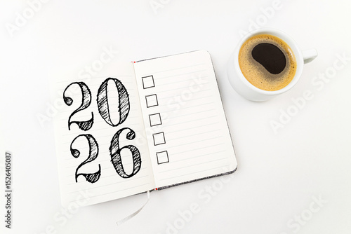 New year resolutions 2026 on desk. 2026 goals list with notebook, coffee cup on white. Resolutions, plan, goals, action, checklist, idea concept. New Year 2026 resolutions, copy space