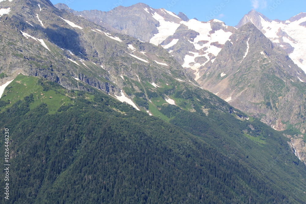 Naklejka premium non-melting snow in the mountains of the North Caucasus in Dombai on a sunny summer day