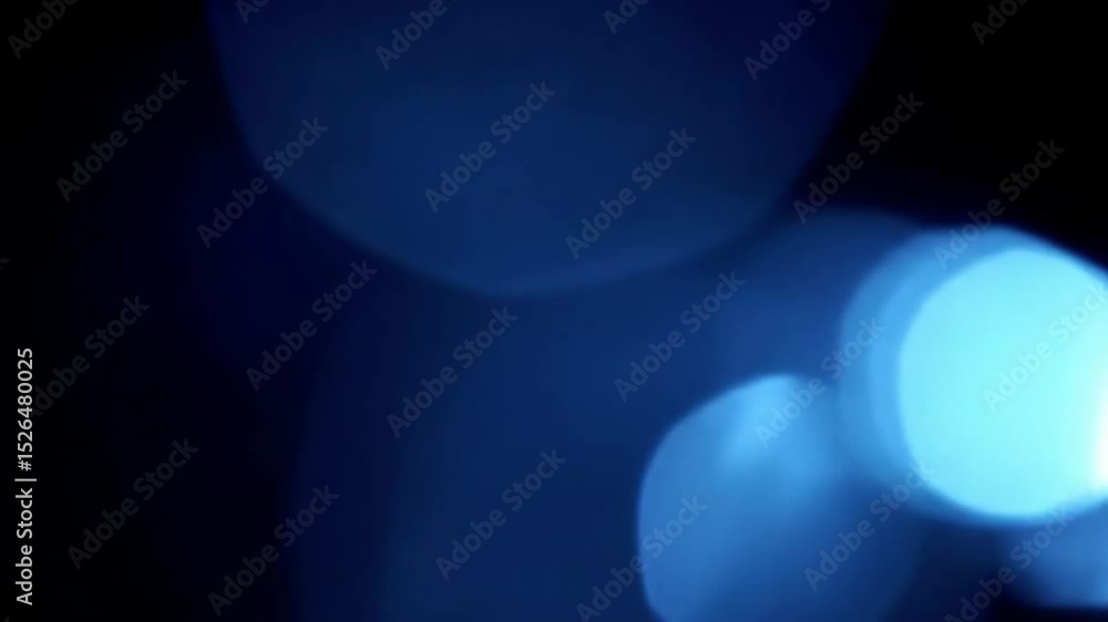 Dynamic blue lens flare effect on a black background, with bright light rays and bokeh. Perfect for cinematic transitions and futuristic themes.