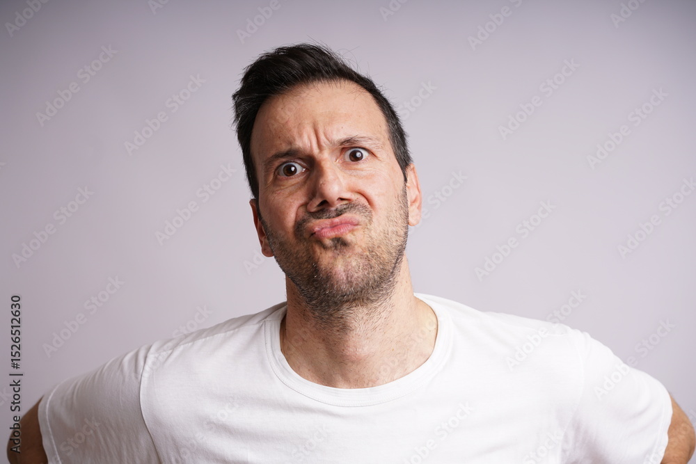 Fototapeta premium Male Model Showing Different Emotions on White Studio Background