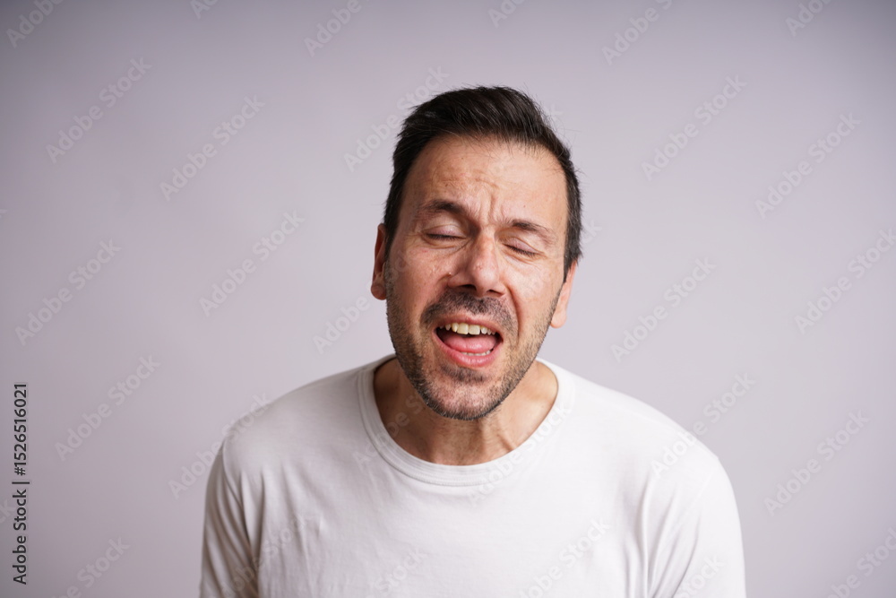 Obraz premium Male Model Showing Different Emotions on White Studio Background