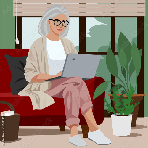 senior woman sitting on a sofa with laptop