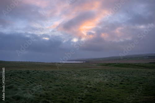 Grassy landscape with mounds of the cliffs of Downpatrick Head with the Atlantic Ocean Co. Mayo, Connacht province, Ireland.