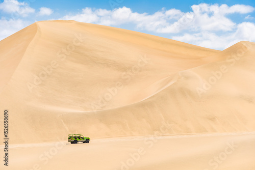 Fototapeta Naklejka Na Ścianę i Meble -  A single buggy car on the sand dunes in the desert of Ica in Huacachina, Peru.