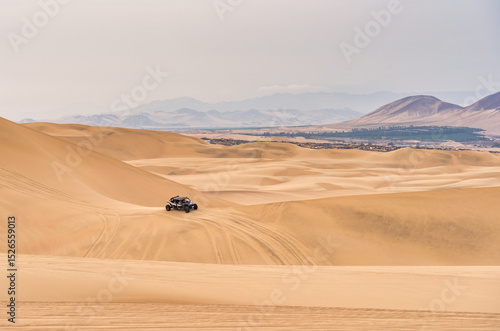 Fototapeta Naklejka Na Ścianę i Meble -  Buggy car on the sand dunes in the desert of Ica in Huacachina, Peru.
