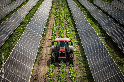 Tractor is driving through a field of solar panels
