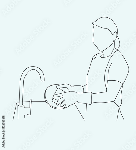 woman washing dishes.Woman washing dishes in apron at kitchen sink