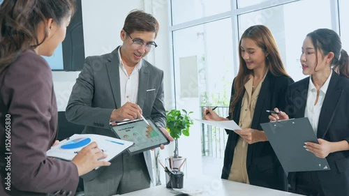 Businesswoman in meeting with tablet or graph for teamwork, data analysis or research. Consultant in front of screen in new corporate office.