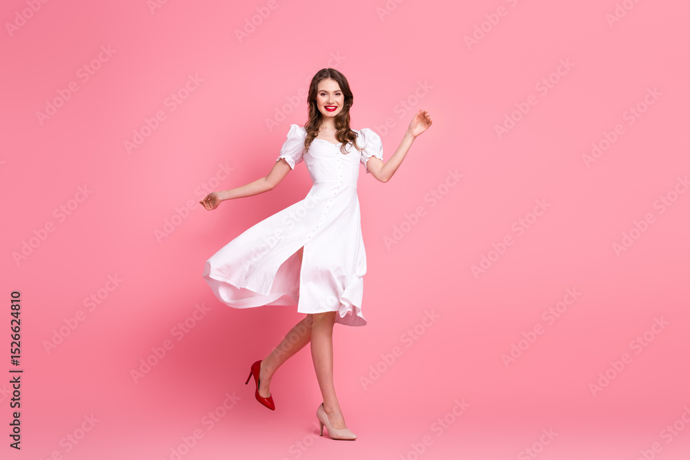 Charming young woman in elegant white dress posing on pink background showing joyful expression and vibrant style Charming young woman in elegant white dress posing on pink background showing joyful expression and vibrant style