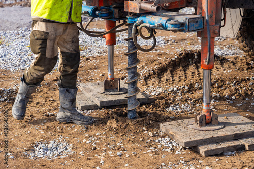 Close-up of soil sampling during pile drilling process. Extraction of subsurface material for geotechnical analysis and foundation assessment
