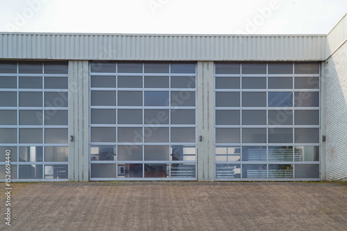 Three sectional garage doors showing industrial interior