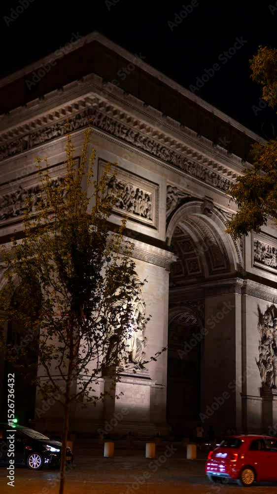 Illuminated Arc de Triomphe with traffic at night in Paris Illuminated Arc de Triomphe with traffic at night in Paris