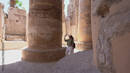 Tourist exploring karnak temple columns montage