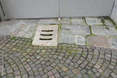 Wallpaper Mural Street drainage system, manhole grill on the street in the city. Sewer Cover. Grate opening on the road. Trash blocking storm drain gutter. To prevent excess water masses or flood on the surface. Torontodigital.ca