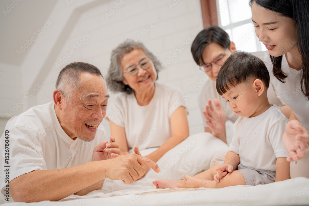 Family gathering in a cozy room as grandparents interact with a toddler during a joyful afternoon Family gathering in a cozy room as grandparents interact with a toddler during a joyful afternoon