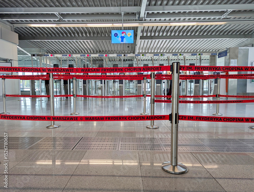 Warsaw Chopin International Airport (Lotnisko Chopina). Red barrier tapes on the counters, airport barrier tapes used to organize queues