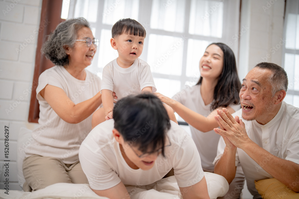 Family gathering in a bright room with joyful interactions among grandparents, parents, and child during a fun playtime moment Family gathering in a bright room with joyful interactions among grandparents, parents, and child during a fun playtime moment