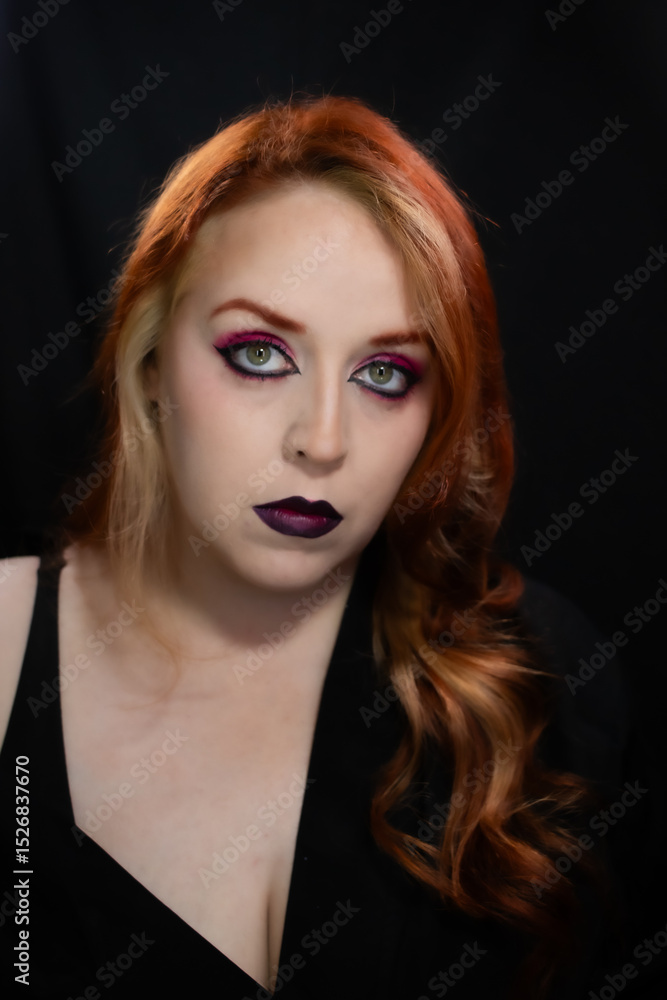 Fototapeta premium Gothic-inspired makeup with bold burgundy lips, vibrant pink eyeshadow, sharp eyeliner, and layered chokers. A dramatic and edgy look perfect for alternative fashion lovers.