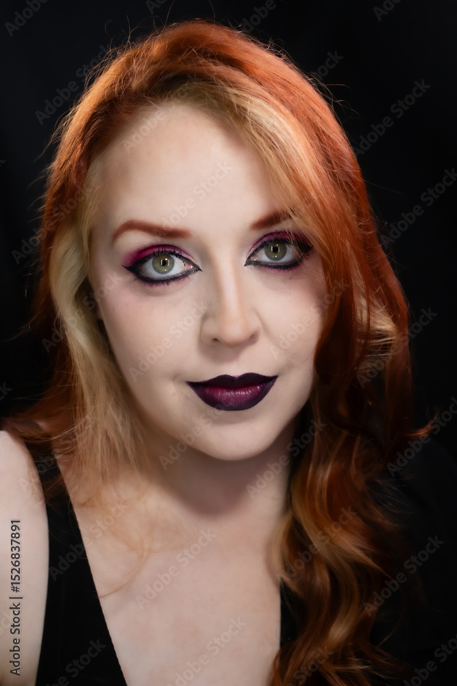 Fototapeta premium Gothic-inspired makeup with bold burgundy lips, vibrant pink eyeshadow, sharp eyeliner, and layered chokers. A dramatic and edgy look perfect for alternative fashion lovers.