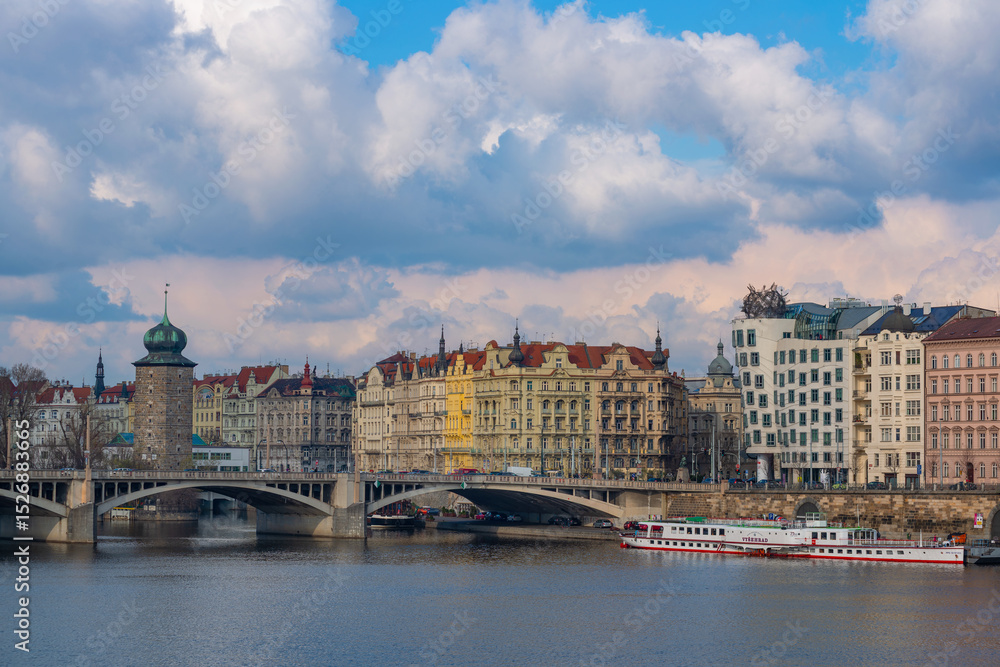 Obraz premium Picturesque view of the Vltava River in the center of the capital of the Czech Republic, Prague, on a spring day