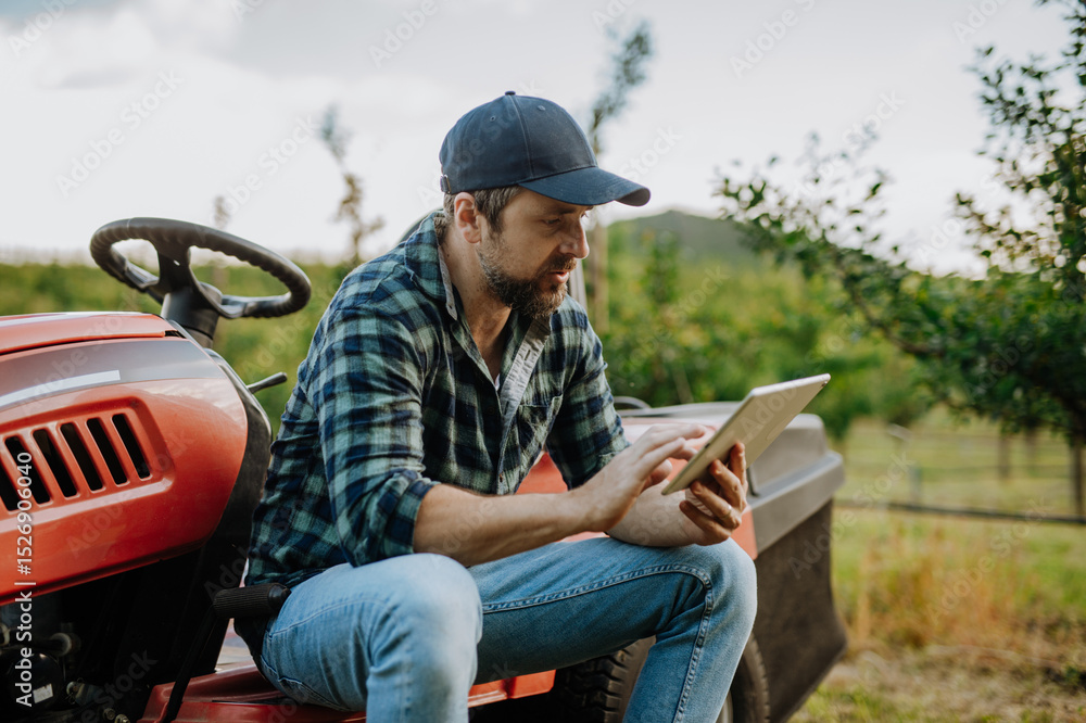 Fototapeta premium Digital agriculture tools help farmer manage orchard.