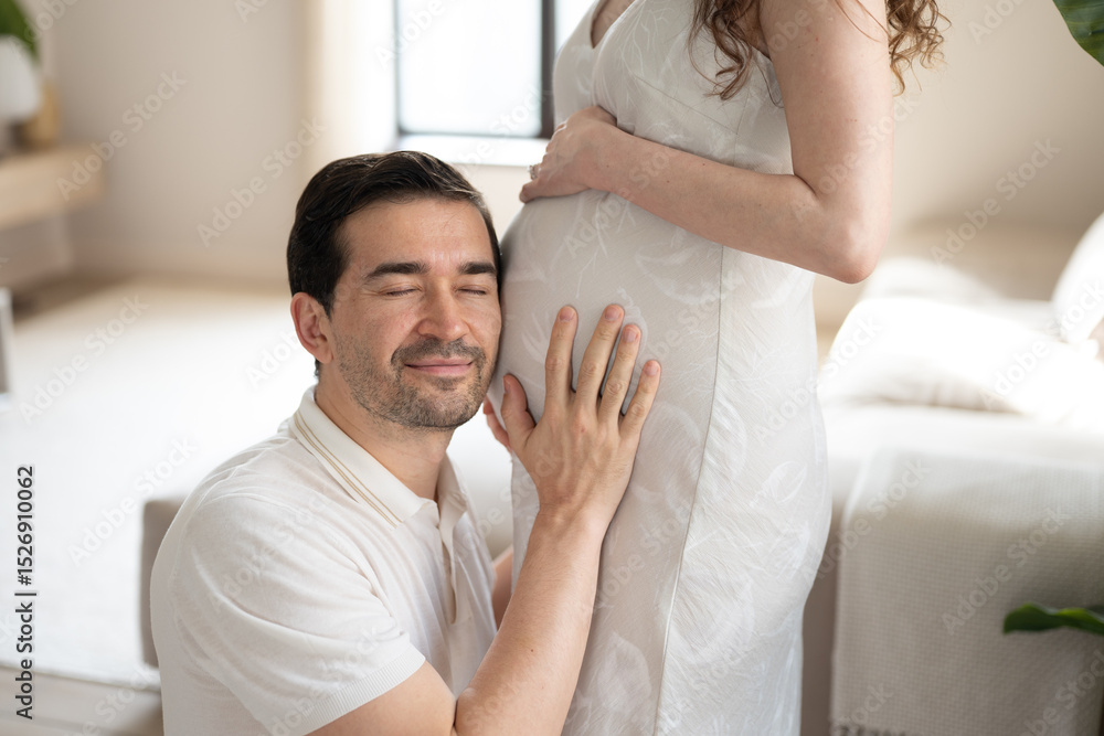 Loving future father embracing his wife's pregnant belly, cherishing moments of anticipation and joy during their time at home Loving future father embracing his wife's pregnant belly, cherishing moments of anticipation and joy during their time at home