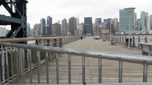 New York City waterfront skyline, Manhattan Midtown buildings, riverfront skyscrapers by East river water. Waterside cityscape view, Gantry Plaza pier, Long Island, Queens. United States architecture.