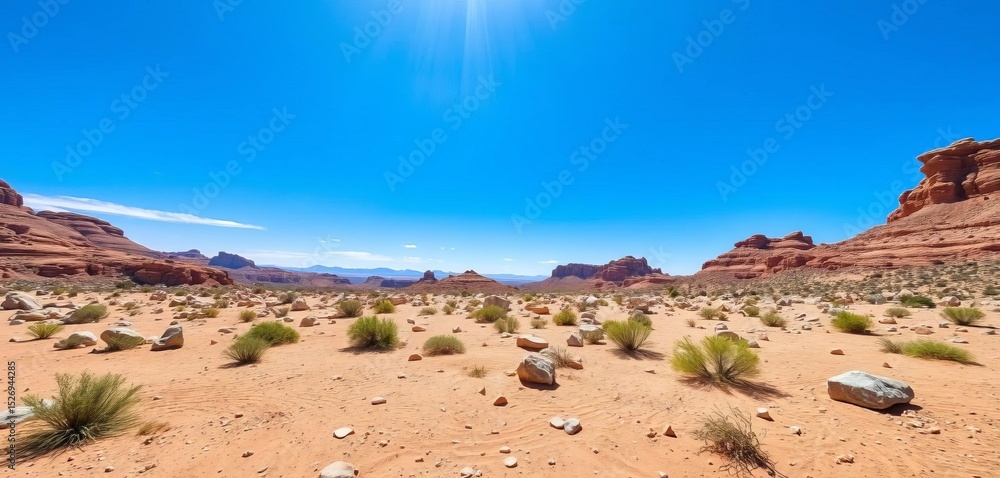Fototapeta premium Arid stone desert landscape under a vibrant blue sky; sparse vegetation and scattered rocks bathed in sunlight, dry, design