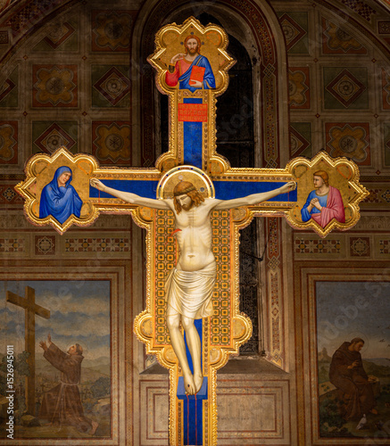 FLORENCE, ITALY - MARCH 17, 2025: The medieval painting of Crucifixion in the church chiesa di San Salvatore in Ognissanti by Giotto (1315).