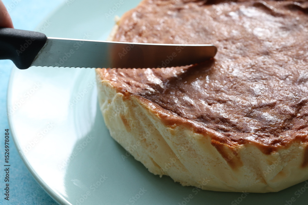 Fototapeta premium San Sebastian cheesecake on plate in restaurant in close-up