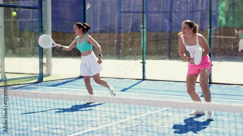 Woman playing with other paddle tennis players. Tennis players participate in a tournament and hit balls to get points