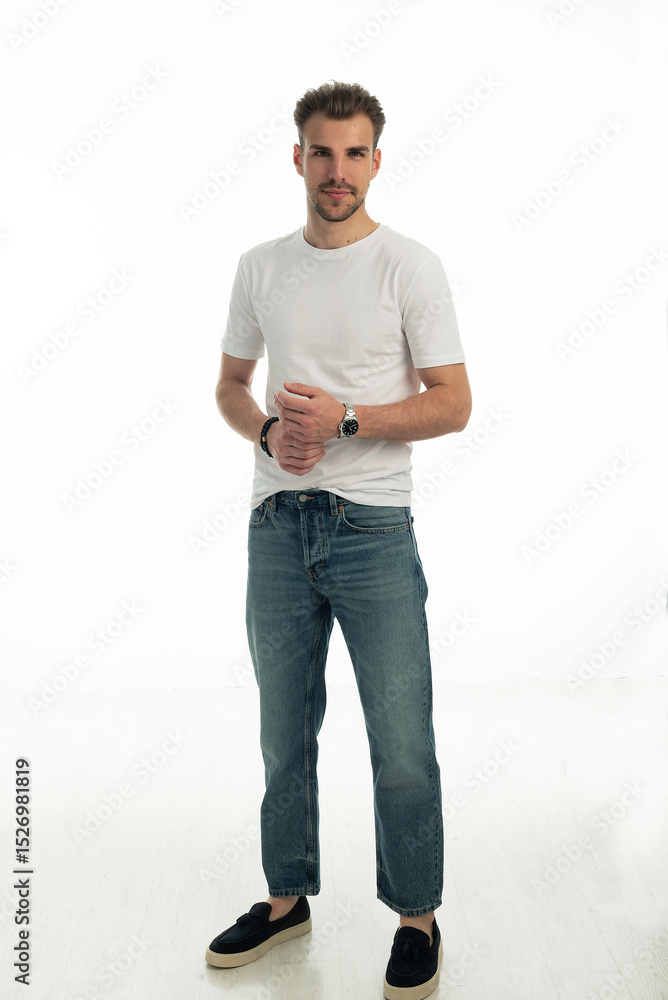 Fototapeta premium Confident young man standing against isolated white background