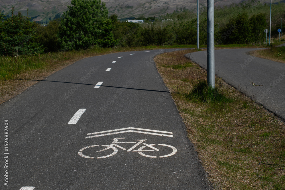 Fototapeta premium Bicycle lane in Mosfellsbær, Iceland surrounded by scenic greenery and countryside