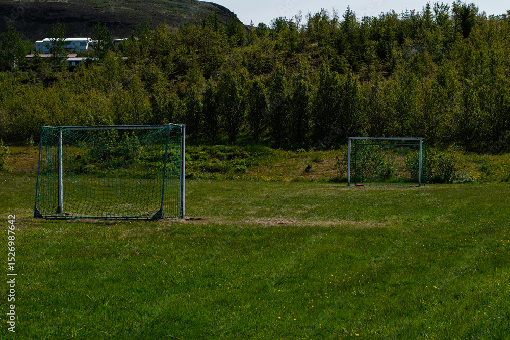 Fototapeta premium Outdoor soccer goals on a lush field in Mosfellsbær, Iceland