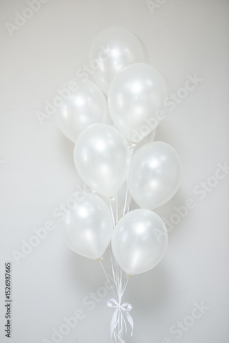 white pearl balloons with helium in a bunch for a holiday