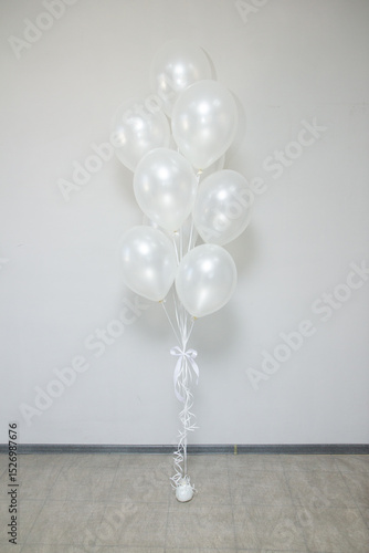 white pearl balloons with helium in a bunch for a holiday