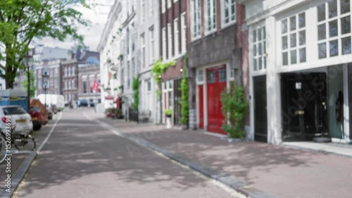 Wallpaper Mural Blurred cityscape of amsterdam with defocused street view and charming architecture under bright daylight. Torontodigital.ca