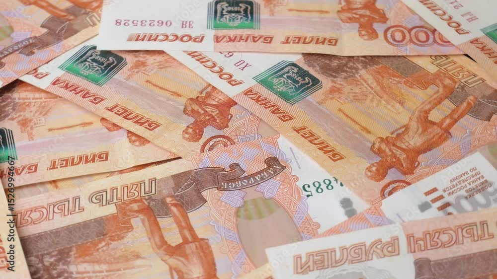 Close-up of the Bank of Russia banknotes with a face value of five thousand rubles, rotating in a circle. Background with Russian paper money. The concept of finance, inflation and sanctions.