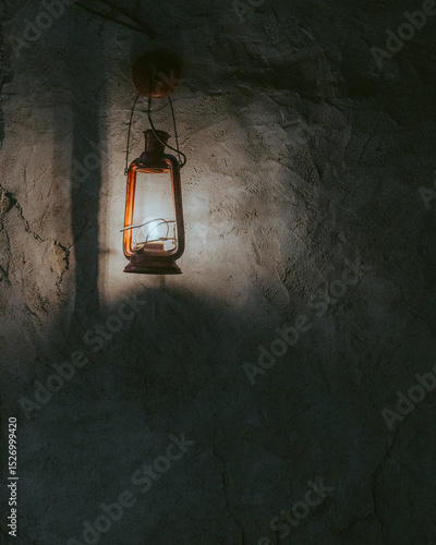 An old lantern hangs on the wall