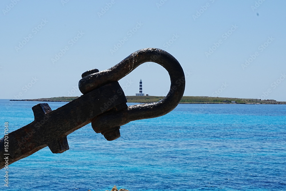 Fototapeta premium Lighthouse in the distance through an anchor loop