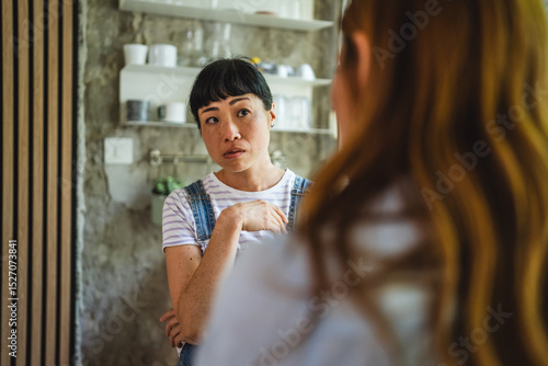 Free Download Two multicultural diverse women stand in the kitchen and arguing - GFXLoad