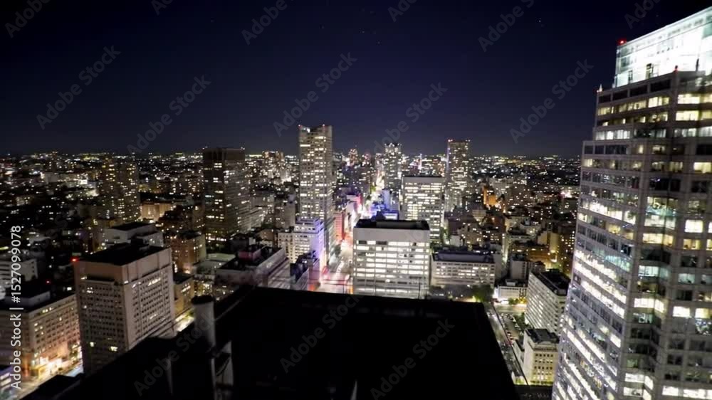 A view of the city from the top of a tall building at night, showing ...