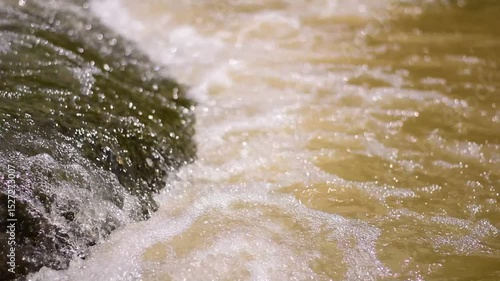 A serene river flows powerfully through a lush, waters cascading down a mountain slope,Red flood water flows from the mountains, Nature of forests and red streams formed by the previous heavy rain