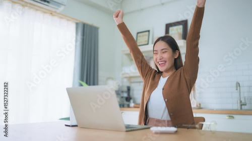 Funny euphoric young asian woman celebrating winning or getting ecommerce shopping offer on computer laptop. Excited happy girl winner looking at notebook celebrating success