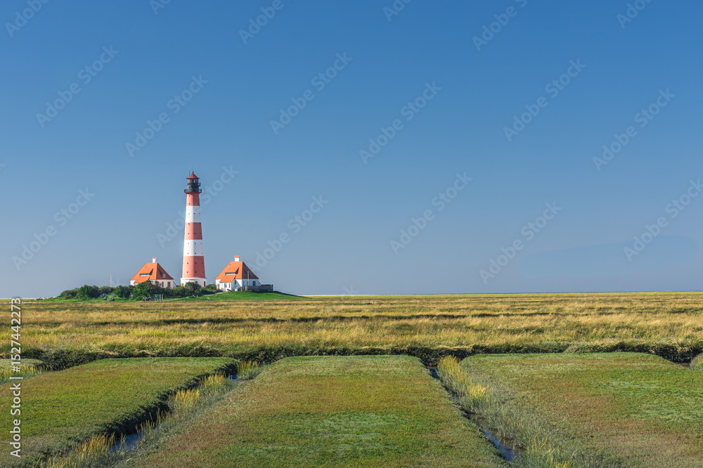 View of the salt marshes and tidal creeks towards the Westerheversand lighthouse, Westerhever, Eiderstedt, North Frisia, Schleswig-Holstein, Germany View of the salt marshes and tidal creeks towards the Westerheversand lighthouse, Westerhever, Eiderstedt, North Frisia, Schleswig-Holstein, Germany