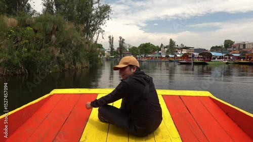 Enjoying a tranquil ride through Xochimilco's colorful trajineras in Mexico